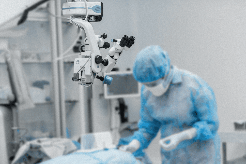 An ophthalmologist prepares a surgical space with ophthalmic equipment.