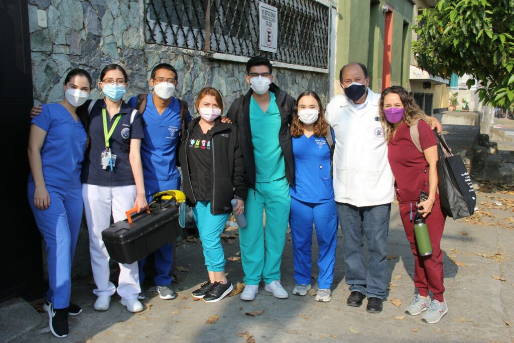 a group of people in scrubs and masks posing for a picture