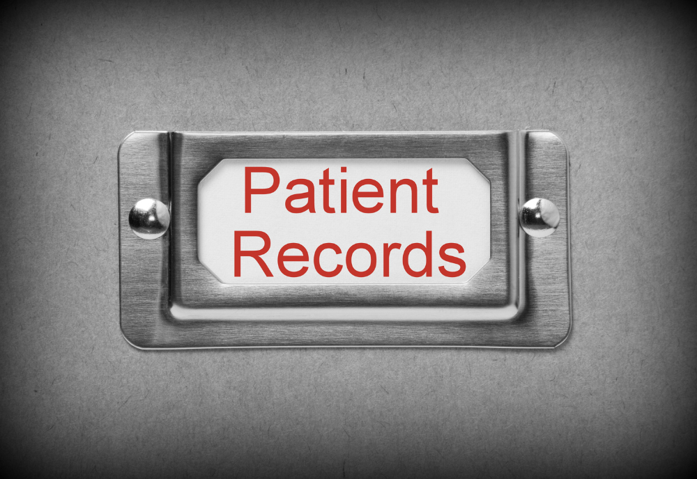 A close-up of a metal box filled with neatly arranged patient records, emphasizing the importance of organized healthcare documentation.