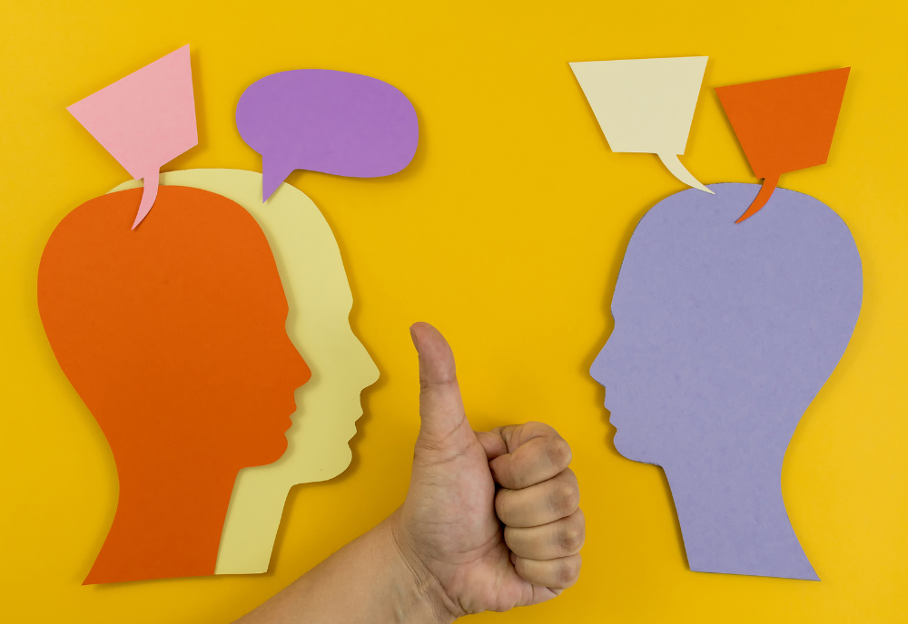 Three individuals on a yellow background, each with a speech bubble, engaged in conversation.