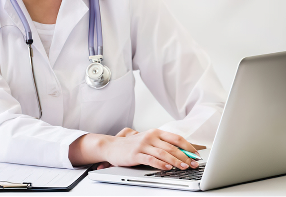 A doctor in a white coat typing on a laptop, focused on patient information in a clinical setting.
